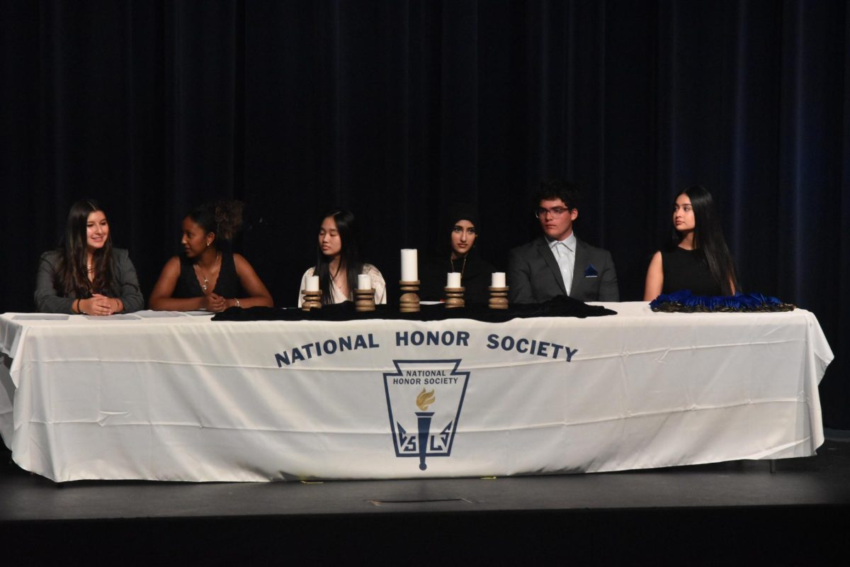 Presidents Danielle Alvarez, Eliana Tamrat, Amanda Lu, Safa Ali, Joshua Stone and Daisy Rodriguez light the candles for each pillar of National Honor Society. Each president said a small speech then lit the candle memorially. “We were super excited for this year's NHS inductions,” Rodriguez said.