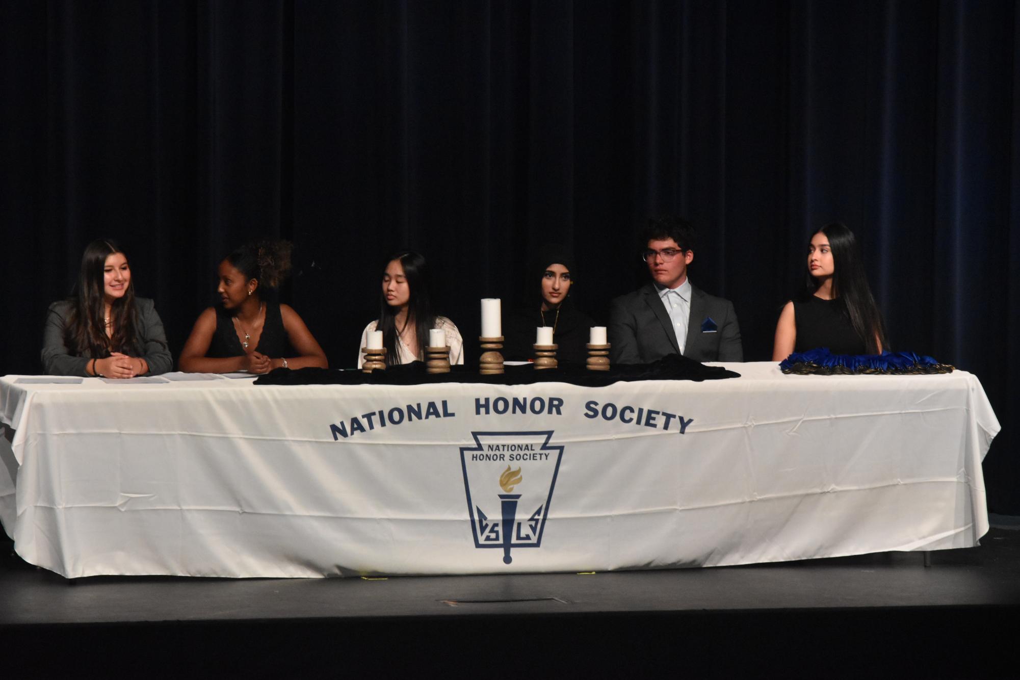 Presidents Danielle Alvarez, Eliana Tamrat, Amanda Lu, Safa Ali, Joshua Stone and Daisy Rodriguez light the candles for each pillar of National Honor Society. Each president said a small speech then lit the candle memorially. “We were super excited for this year's NHS inductions,” Rodriguez said.