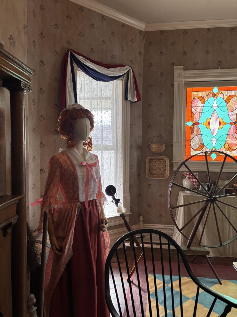 Heart of History// The woman’s room in the Brown House, complete with a wheel stained glass, and wallpaper; the dress displayed hand sewn by Tracy Lawson.